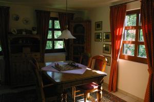 a dining room with a table and chairs and windows at Ferienwohnung Erzgebirge in Pockau