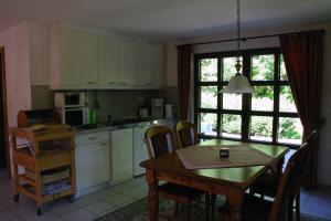 a kitchen and dining room with a table and a table and chairs at Ferienwohnung Erzgebirge in Pockau