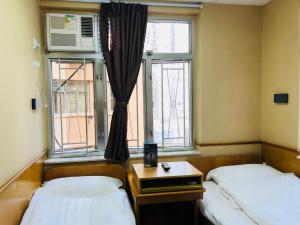 Postel nebo postele na pokoji v ubytování Good Fortune Inn