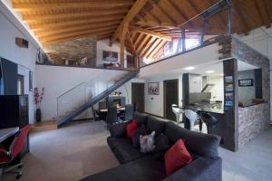 a living room with a couch and a staircase at La Morada de Andoin in Andoín