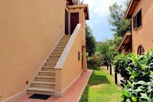 a stairway leading up to a building with a door at Agriturismo Pimpinnacolo in Porto Ercole