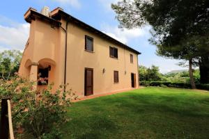 a house with a large yard in front of it at Agriturismo Pimpinnacolo in Porto Ercole
