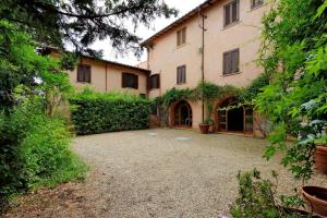 a large building with a courtyard in front of it at Agriturismo Pimpinnacolo in Porto Ercole