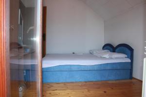 ein kleines Bett in einem Zimmer mit Glastür in der Unterkunft Prosper in Sarajevo