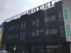 a black building with a sign on top of it at 68 Boutique Hotel in Sitiawan