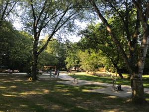 a park with trees and people walking on a path at TM Hotel Dortmund Airport in Holzwickede