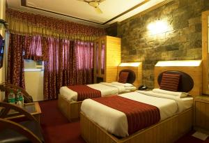 Postel nebo postele na pokoji v ubytování Hotel Lal's Haveli