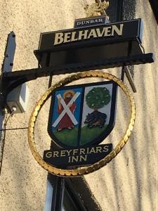 um sinal na lateral de um edifício em Greyfriars Inn by Greene King Inns em St. Andrews