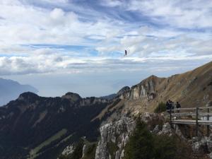 a person flying a kite on top of a mountain at Roc d'Orsay E51 in Leysin