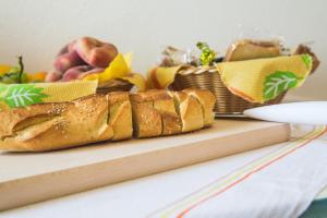 um pedaço de pão sentado numa tábua de cortar com fruta em B&B Alla Cattedrale em Agrigento