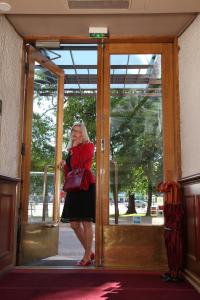 a woman standing in the door of a bus at Hotel Astor in Vaasa