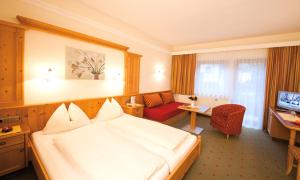 Łóżko lub łóżka w pokoju w obiekcie Hotel Garni Forelle