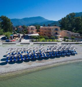 a group of chairs and umbrellas on a beach at Akroyiali Resort in Vasiliki