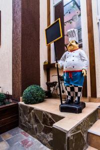 a statue of a chef standing on a ledge at Art Hotel in Krasnodar