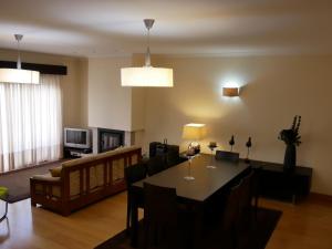 a living room with a dining table and a couch at Casa Casais in Fão