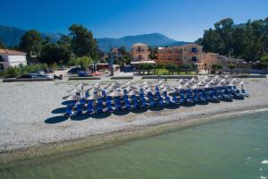 a group of chairs and umbrellas on a beach at Akroyiali Resort in Vasiliki