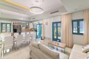a living room with a couch and a table at Royal Villa Pedi in Symi