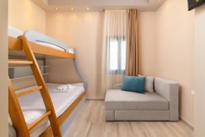 a small room with a bunk bed and a chair at Royal Villa Pedi in Symi
