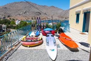 a group of kayaks and kayaks sitting on a balcony at Royal Villa Pedi in Symi