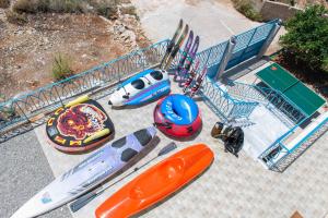 a group of surfboards are lined up next to a pool at Royal Villa Pedi in Symi