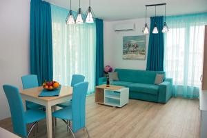 a living room with a blue couch and a table at Old Sailor Apartment in Obzor