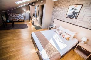 a bedroom with a large bed and a living room at Art Hotel in Krasnodar