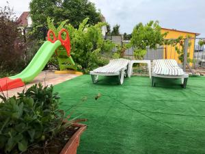 a backyard with two benches and a slide at Dacha U Morya in Odesa