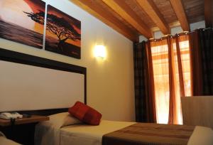 Postel nebo postele na pokoji v ubytování Hotel Villa Altura