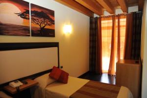 Postel nebo postele na pokoji v ubytování Hotel Villa Altura
