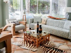 a living room with a zebra rug and a table at Pictures Guest House Boutique Hotel in Oudtshoorn