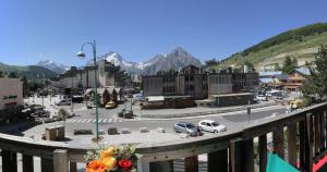 a city with a lot of buildings and a mountain range at Hotel le Sherpa in Les Deux Alpes