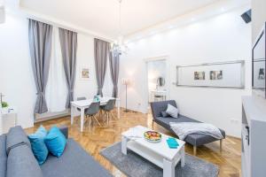 uma sala de estar com um sofá e uma mesa em Dominik Apartment em Budapeste