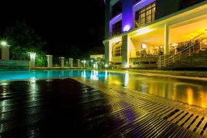an empty street in front of a building at night at Kilimanjaro Wonders Hotel in Moshi