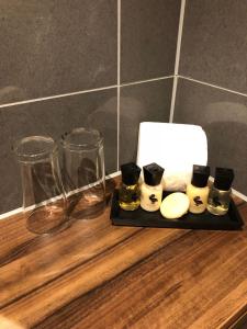 a tray with glasses and other items on a counter at Rivington Lodge in Bolton