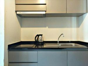 a kitchen with a sink and a counter top at Replay Condo Studio Room in Bang Rak Beach