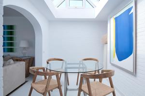 a dining room with a glass table and two chairs at Villas Pasito Blanco in Pasito Blanco