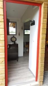 an open door to a room with a table at La THIBAUDIERE Tilleul in Châlus