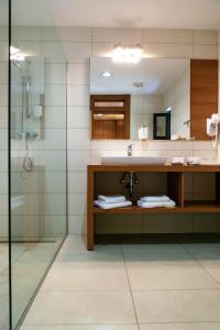 a bathroom with a sink and a shower at Hotel Laguna - Terme Krka in Strunjan