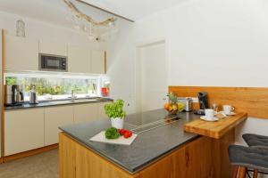 a kitchen with a counter with fruits and vegetables on it at Lotsenstieg 13b in Ostseebad Karlshagen