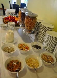 a table with bowls of food and plates of food at Hotel Beach in Tortoreto Lido