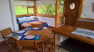 a small room with a table and a bed at Blue Bird House in San Carlos de Bariloche
