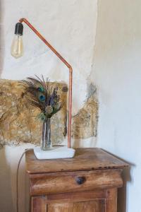 a lamp on top of a table with a vase of flowers at joangi in Uhart-Cize