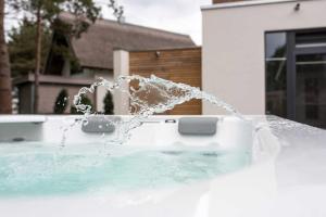 a water fountain in a tub in front of a house at Kapitaensweg 12 in Ostseebad Karlshagen +29 photos