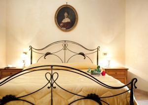 a bedroom with a bed with a picture on the wall at Hotel Villa Torre Antica in Atena Lucana