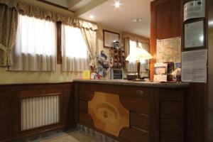 a hotel room with a reception desk and a window at B & B La Pineta By La Capannina in Roccaraso