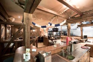 a restaurant with a kitchen with wooden beams at Hotel Linde in Günzburg