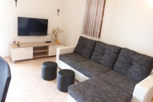 a living room with a couch and a flat screen tv at Vacation Home Katarina in Nin +26 photos