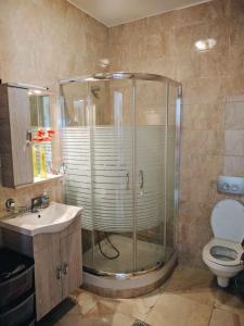 a bathroom with a shower and a sink and a toilet at APARTMENTS by the SEA in Leptokarya +23 photos