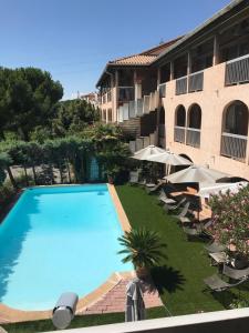 a large swimming pool in front of a building at Hôtel Belvedère Cannes Mougins in Mougins