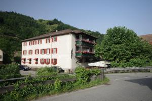 a white building with balconies on the side of it at Gasthof und Pension zum Kreuz in Lautenbach